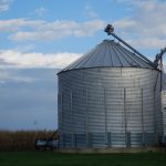 An agronomy blog image showing grain bins during harvest.