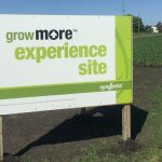 This image shows a Grow More Experience sign promoting field trials in Slater, Iowa.